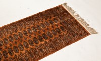 Lot 420 - BOKHARA RUNNER with two rows of guls on a pale...