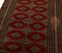 Lot 431 - BOKHARA RUG with two rows of guls on a red...