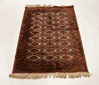 Lot 432 - BOKHARA RUG with claret guls on an ivory field,...