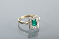 Lot 1104 - EMERALD AND DIAMOND CLUSTER RING set with a...