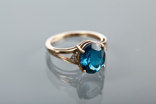 Lot 1122 - TOPAZ AND DIAMOND DRESS RING set with an oval...