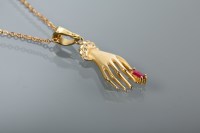 Lot 1206 - GOLD HAND MOTIF PENDANT the hand clasping a...