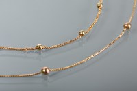 Lot 1210 - TWO NINE CARAT GOLD CHAINS each set with...