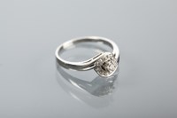 Lot 1266 - DIAMOND CLUSTER RING with a central brilliant...