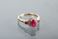 Lot 1270 - RUBY AND DIAMOND CLUSTER RING with a central...