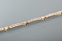 Lot 1278 - FOURTEEN CARAT GOLD GEM SET BRACELET set with...
