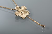 Lot 1280 - GOLD FLORAL MOTIF PENDANT on a chain, all in...