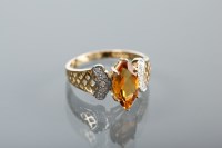 Lot 1285 - CITRINE AND DIAMOND DRESS RING set with a...