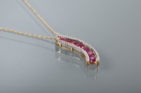 Lot 1294 - RUBY AND DIAMOND PENDANT of curved form, set...