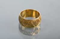 Lot 1325 - EIGHTEEN CARAT GOLD WEDDING BAND with engraved...