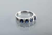 Lot 1350 - SAPPHIRE AND DIAMOND RING set with oval...