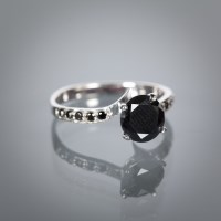 Lot 1360A - BLACK DIAMOND DRESS RING the central brilliant...