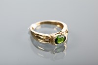 Lot 1369 - PERIDOT DRESS RING the oval peridot on diamond...