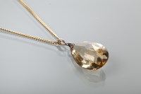 Lot 1385 - CITRINE PENDANT the large pear shaped stone on...