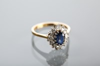 Lot 1389 - SAPPHIRE AND DIAMOND CLUSTER RING the central...