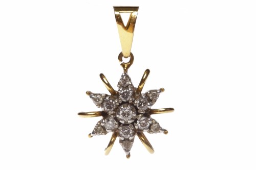 Lot 56 - DIAMOND SET PENDANT with a central round...