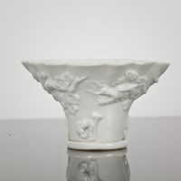 Lot 49 - CHINESE BLANC DE CHINE LIBATION CUP decorated...