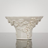 Lot 51 - CHINESE BLANC DE CHINE LIBATION CUP decorated...