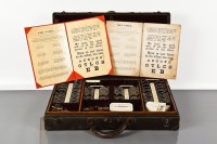 Lot 345 - EARLY 20TH CENTURY OPTICIANS LENS SET in a...