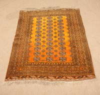 Lot 404 - ANTIQUE BOKHARA RUG with rows of guls on an...