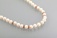 Lot 1128 - PEARL AND RUBY NECKLACE formed by spherical...