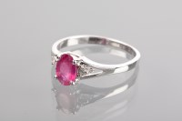 Lot 1135 - RUBY AND DIAMOND RING set with an oval cut...