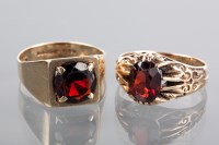 Lot 1163 - TWO GENTLEMAN'S GARNET RINGS both in nine...