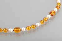 Lot 1164 - AMBER AND PEARL BEAD NECKLACE formed by...