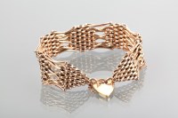 Lot 1171 - NINE CARAT GOLD BRACELET with a heart shaped...