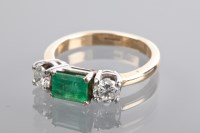 Lot 1179 - EMERALD AND DIAMOND THREE STONE RING the...