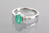 Lot 1196 - EMERALD AND DIAMOND THREE STONE RING the...