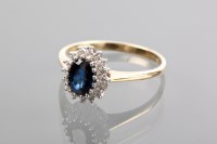 Lot 1210A - SAPPHIRE AND DIAMOND CLUSTER RING the central...