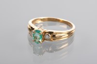 Lot 1220 - EMERALD AND DIAMOND RING the central oval...