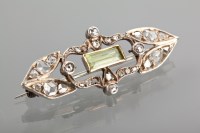 Lot 1237 - EDWARDIAN DIAMOND AND PERIDOT BROOCH set with...