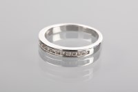 Lot 1243 - DIAMOND HALF ETERNITY RING channel set with...