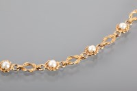 Lot 1257 - NINE CARAT GOLD PEARL SET BRACELET with round...