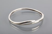 Lot 1274 - NINE CARAT WHITE GOLD BANGLE of oval form,...