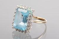 Lot 1296 - TOPAZ AND DIAMOND DRESS RING the large emerald...