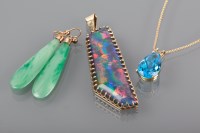 Lot 1313 - OPAL SIMULANT PENDANT the large stone set in...