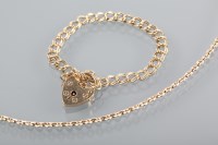 Lot 1320 - NINE CARAT GOLD BRACELET with a padlock clasp;...