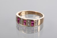 Lot 1339 - RUBY AND DIAMOND RING with channel set step...