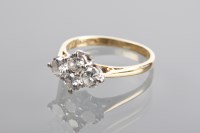 Lot 1366 - DIAMOND DRESS RING set with four brilliant cut...