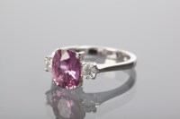 Lot 1398 - PINK SAPPHIRE AND DIAMOND THREE STONE RING the...