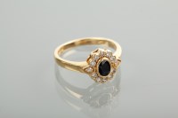 Lot 1102 - SAPPHIRE AND DIAMOND CLUSTER RING set with a...