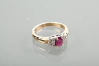 Lot 1120 - RUBY AND DIAMOND RING set with an oval cut...