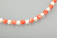 Lot 1122 - CORAL AND PEARL NECKLACE with round coral...