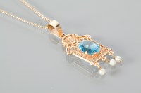 Lot 1128 - TOPAZ AND SEED PEARL PENDANT with a pierced...