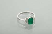 Lot 1140 - EMERALD AND DIAMOND THREE STONE RING the...