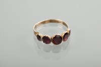 Lot 1159 - FOILED GARNET FIVE STONE RING set with five...