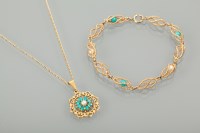 Lot 1165 - TURQUOISE AND SEED PEARL PENDANT of scrolling...